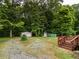 Spacious backyard featuring a shed and mature trees at 605 Mace Rd, Mebane, NC 27302