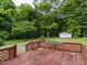 Expansive backyard with a wooden deck and lush greenery at 605 Mace Rd, Mebane, NC 27302