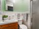 Well-maintained bathroom features green walls, a shower, and a classic vanity with ample lighting at 605 Mace Rd, Mebane, NC 27302