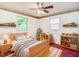 Bright bedroom with unique toy decor, featuring a ceiling fan, natural light, and charming accents at 605 Mace Rd, Mebane, NC 27302