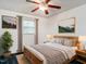 Well-lit bedroom with a wooden bed frame and neutral decor at 605 Mace Rd, Mebane, NC 27302