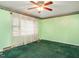 Bedroom featuring green walls, neutral trim and carpet, with a ceiling fan, waiting for the new homeowner's personal touch at 605 Mace Rd, Mebane, NC 27302