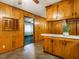 Efficient kitchen with wood cabinets, white countertops, and tile flooring, with a doorway leading to another room at 605 Mace Rd, Mebane, NC 27302