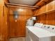 Functional laundry room with wood paneling and a washer/dryer at 605 Mace Rd, Mebane, NC 27302