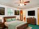 Main bedroom features ceiling fan, light green accents, and en-suite bathroom with convenient access at 605 Mace Rd, Mebane, NC 27302
