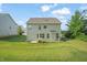 Rear exterior of the home displays a large, well-manicured backyard with ample space at 672 Millers Mark Ave, Wake Forest, NC 27587