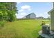 Expansive backyard with lush green grass, fenced perimeter, and mature trees offers privacy at 672 Millers Mark Ave, Wake Forest, NC 27587