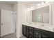 Bathroom with a double sink vanity, modern black cabinets, and stylish fixtures at 672 Millers Mark Ave, Wake Forest, NC 27587