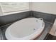 Modern bathroom featuring a soaking tub and stylish tile surround at 672 Millers Mark Ave, Wake Forest, NC 27587