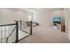 Bright bonus room with plush carpet, comfortable seating and a staircase leading to the floor below at 672 Millers Mark Ave, Wake Forest, NC 27587