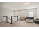 Cozy bonus room with plush carpet, comfortable seating and a staircase leading to the floor below at 672 Millers Mark Ave, Wake Forest, NC 27587