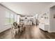 Open-concept dining area leads into a bright kitchen and living space with stairs, offering seamless living and entertaining at 672 Millers Mark Ave, Wake Forest, NC 27587