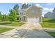 Charming two-story home with a well-manicured lawn and a spacious two-car garage at 672 Millers Mark Ave, Wake Forest, NC 27587