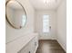 Bright foyer featuring a large round mirror and a modern white console table at 672 Millers Mark Ave, Wake Forest, NC 27587
