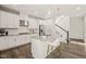 Bright kitchen features white cabinets, granite counters, stainless appliances, and a central island with bar seating at 672 Millers Mark Ave, Wake Forest, NC 27587