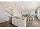 This kitchen has a central island with a sink and faucet, granite countertops, and pendant lighting at 672 Millers Mark Ave, Wake Forest, NC 27587