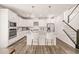 Modern white kitchen with stainless steel appliances, granite countertops and a stylish island at 672 Millers Mark Ave, Wake Forest, NC 27587
