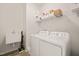 Laundry room featuring a washer, dryer, utility sink, and storage shelves at 672 Millers Mark Ave, Wake Forest, NC 27587