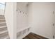 Mudroom features built in hall tree with bench and storage cubbies, located adjacent to carpeted stairs at 672 Millers Mark Ave, Wake Forest, NC 27587