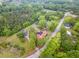 Aerial view showcases the property's setting within a lush, tree-filled landscape at 6720 Dwight Rowland Rd, Willow Springs, NC 27592