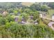 Aerial view of a residential area surrounded by dense green forests and neighborhood amenities at 6720 Dwight Rowland Rd, Willow Springs, NC 27592