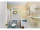 Outdated bathroom with blue fixtures, tiled floor, and window at 6720 Dwight Rowland Rd, Willow Springs, NC 27592