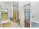 Functional bathroom featuring a double sink, a bathtub with a shower, and a storage area at 6720 Dwight Rowland Rd, Willow Springs, NC 27592
