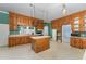 Kitchen with wood cabinets, an island, and an open layout, providing ample workspace at 6720 Dwight Rowland Rd, Willow Springs, NC 27592