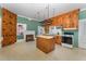 Spacious kitchen with wooden cabinets, an island, and a vintage stove at 6720 Dwight Rowland Rd, Willow Springs, NC 27592