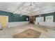 Spacious living room featuring a brick fireplace, textured green walls, and a vintage rug at 6720 Dwight Rowland Rd, Willow Springs, NC 27592