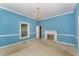 Living room with a decorative fireplace, light fixture, and natural light at 6720 Dwight Rowland Rd, Willow Springs, NC 27592