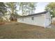 A view of the home's backyard and tan siding at 75 Hartwell Cir, Lillington, NC 27546