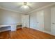 Bedroom with hardwood floors, built-in desk, crown moulding and ceiling fan at 75 Hartwell Cir, Lillington, NC 27546
