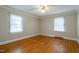 Well lit bedroom featuring hardwood floors, neutral walls, and a ceiling fan at 75 Hartwell Cir, Lillington, NC 27546