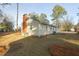 Exterior view of home with brick chimney, green trees, and some landscaping at 75 Hartwell Cir, Lillington, NC 27546