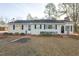 Inviting single-story home boasting classic shutters, lush landscaping, and a welcoming front entrance at 75 Hartwell Cir, Lillington, NC 27546