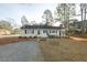 Charming single-story home featuring a gravel driveway, well-kept lawn, and classic curb appeal at 75 Hartwell Cir, Lillington, NC 27546