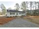 Attractive single-story home with a gravel driveway, black shutters, and a well-manicured front yard at 75 Hartwell Cir, Lillington, NC 27546