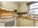 Well-lit kitchen featuring white appliances, and tile countertops at 75 Hartwell Cir, Lillington, NC 27546