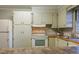 Well-equipped kitchen features updated appliances, ample counter space, and stylish tile backsplash at 75 Hartwell Cir, Lillington, NC 27546