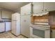 Spacious kitchen including a refrigerator, range, and ample cabinet space at 75 Hartwell Cir, Lillington, NC 27546