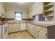 Charming kitchen featuring vintage cabinets, tile backsplash, and tile flooring at 75 Hartwell Cir, Lillington, NC 27546
