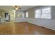 Open-concept living room featuring laminate floors, white trim, and seamless flow into adjacent kitchen at 75 Hartwell Cir, Lillington, NC 27546