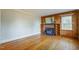 Cozy living room with a wood-burning fireplace, built-in shelving, and hardwood floors at 75 Hartwell Cir, Lillington, NC 27546