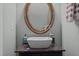 Stylish bathroom features a vessel sink, elegant mirror, and modern fixtures at 7871 Allscott Way, Raleigh, NC 27612
