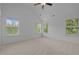 The bright bedroom has a ceiling fan and multiple windows providing ample natural light at 7871 Allscott Way, Raleigh, NC 27612