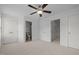 Bright bedroom with neutral carpet, ceiling fan, ensuite bathroom and closet at 7871 Allscott Way, Raleigh, NC 27612