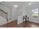 Welcoming entryway with hardwood floors, staircase, and stylish table setup with coffee station at 7871 Allscott Way, Raleigh, NC 27612