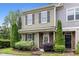 Charming two-story townhome featuring a well-manicured lawn and inviting entrance at 7871 Allscott Way, Raleigh, NC 27612