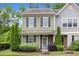 Attractive two-story townhome with neat landscaping, complementary colors, and inviting entrance at 7871 Allscott Way, Raleigh, NC 27612